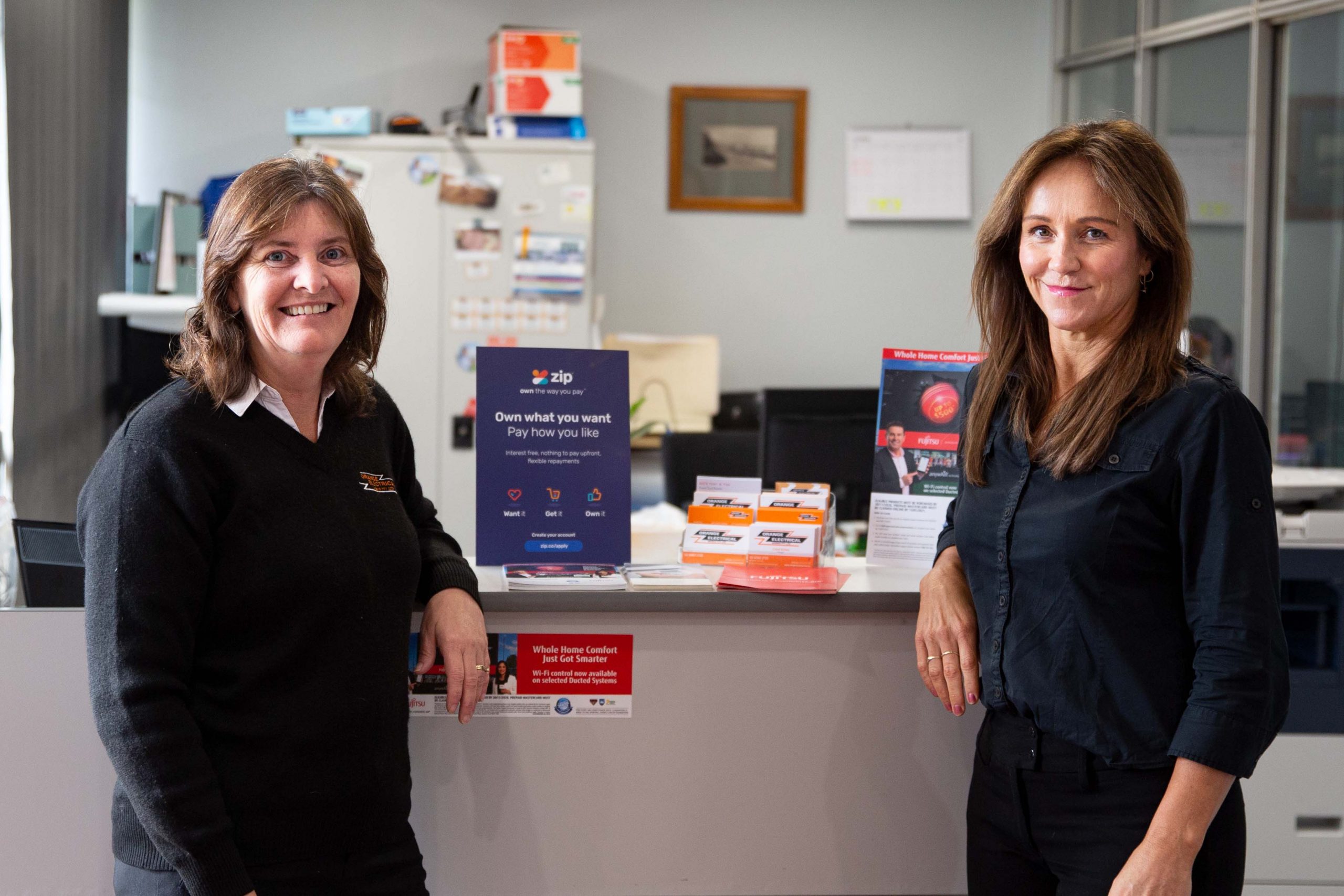 Two administration staff from Orange Electrical Works standing inside our new offices located in Barrett Court, Orange, NSW