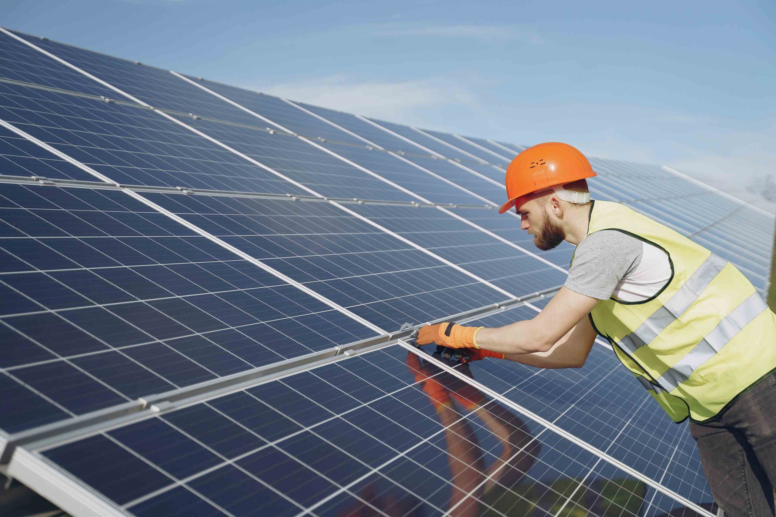 Technician inspecting solar panels